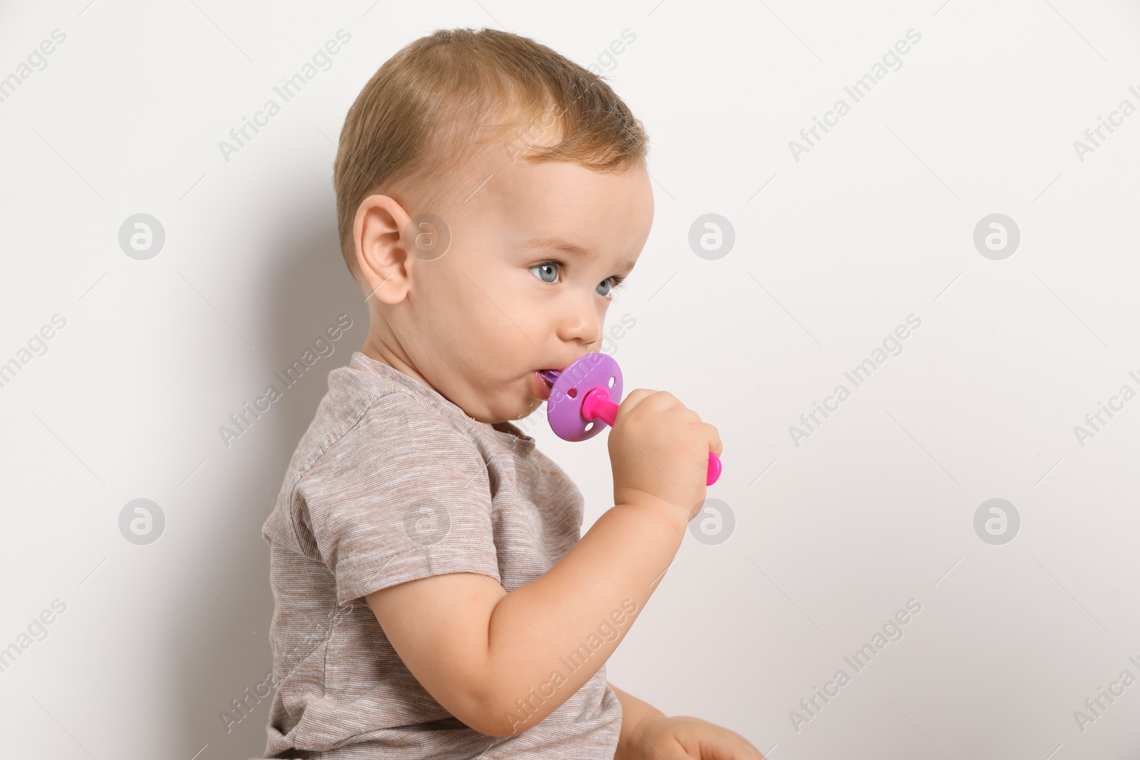 Photo of Cute little boy with toothbrush on white background