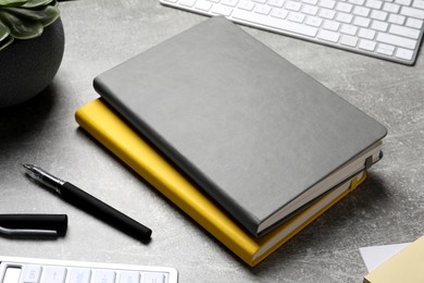 Photo of Composition with stylish notebooks on grey table