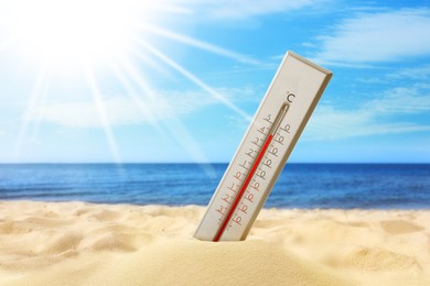 Image of Thermometer on beach showing high temperature during hot summer day