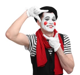 Funny mime artist showing frame gesture on white background