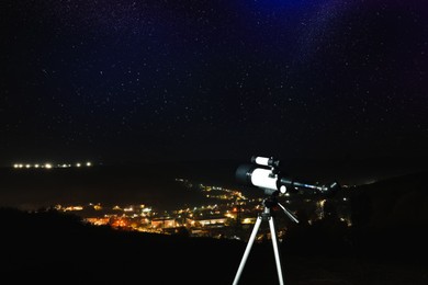 Picturesque view of city and modern telescope in night outdoors. Learning astronomy