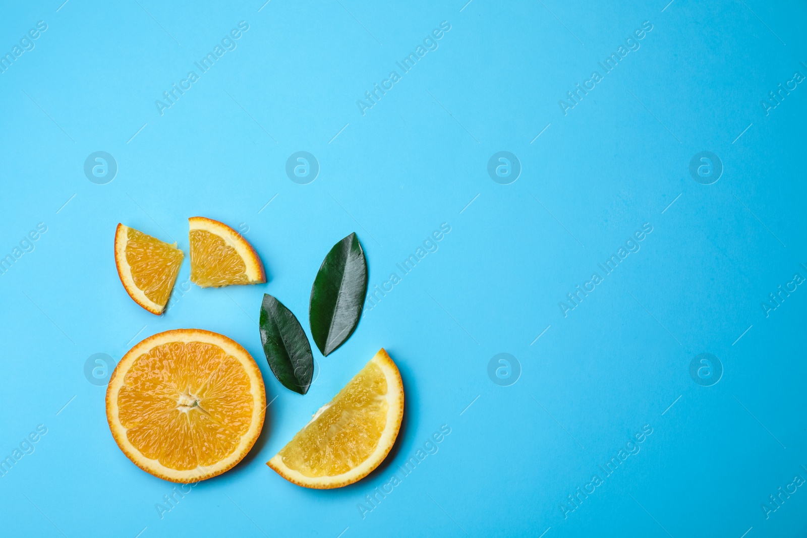 Photo of Flat lay composition with fresh oranges and space for text on color background