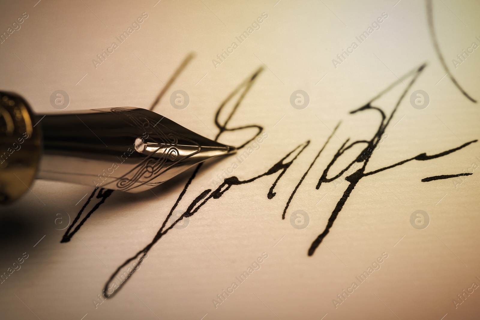 Image of Signing on sheet of paper with fountain pen, closeup