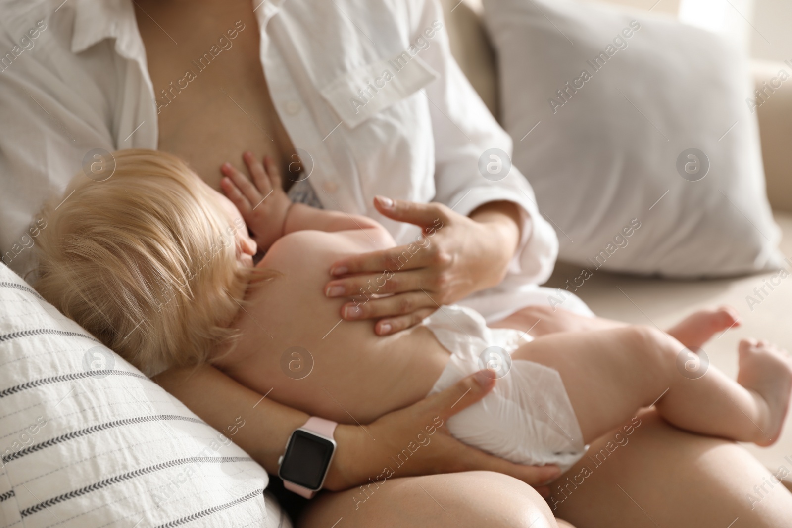 Photo of Mother breastfeeding her little baby at home. Healthy growth