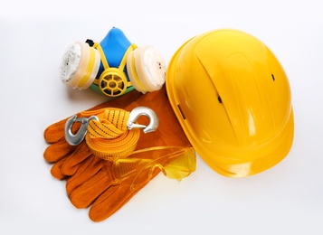 Photo of Protective workwear on white background, top view. Safety equipment