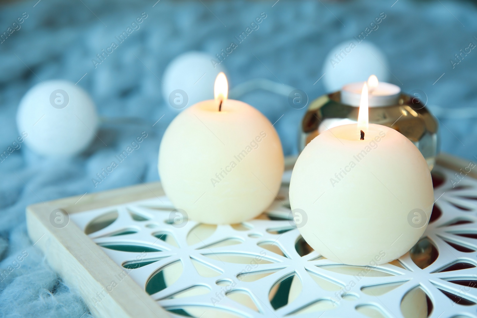 Photo of Burning wax candles on decorative stand. Time to relax