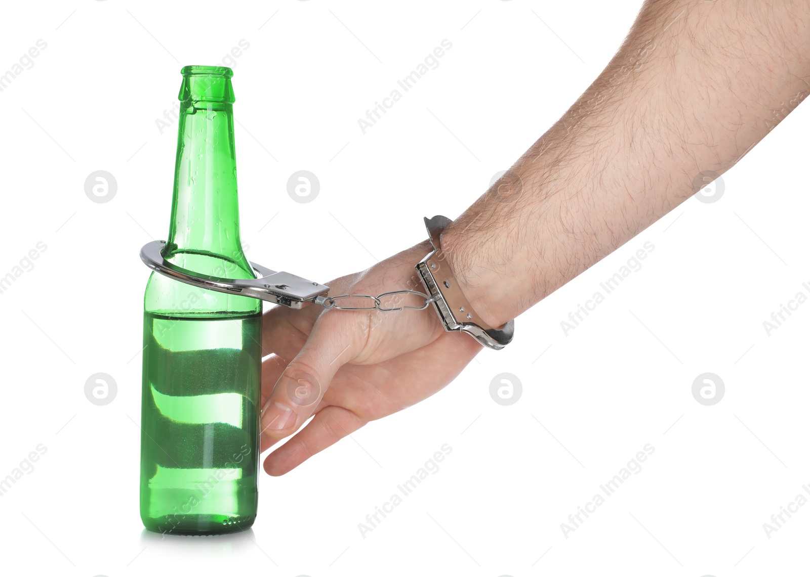 Photo of Man in handcuffs with bottle of beer on white background, closeup. Alcohol addiction