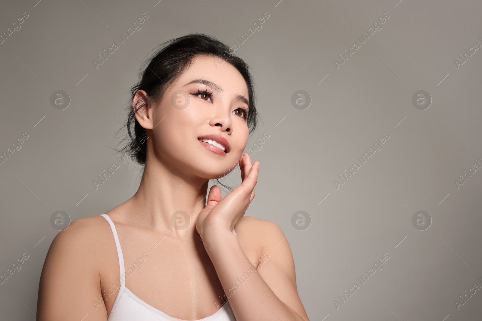 Photo of Portrait of beautiful woman on grey background, space for text