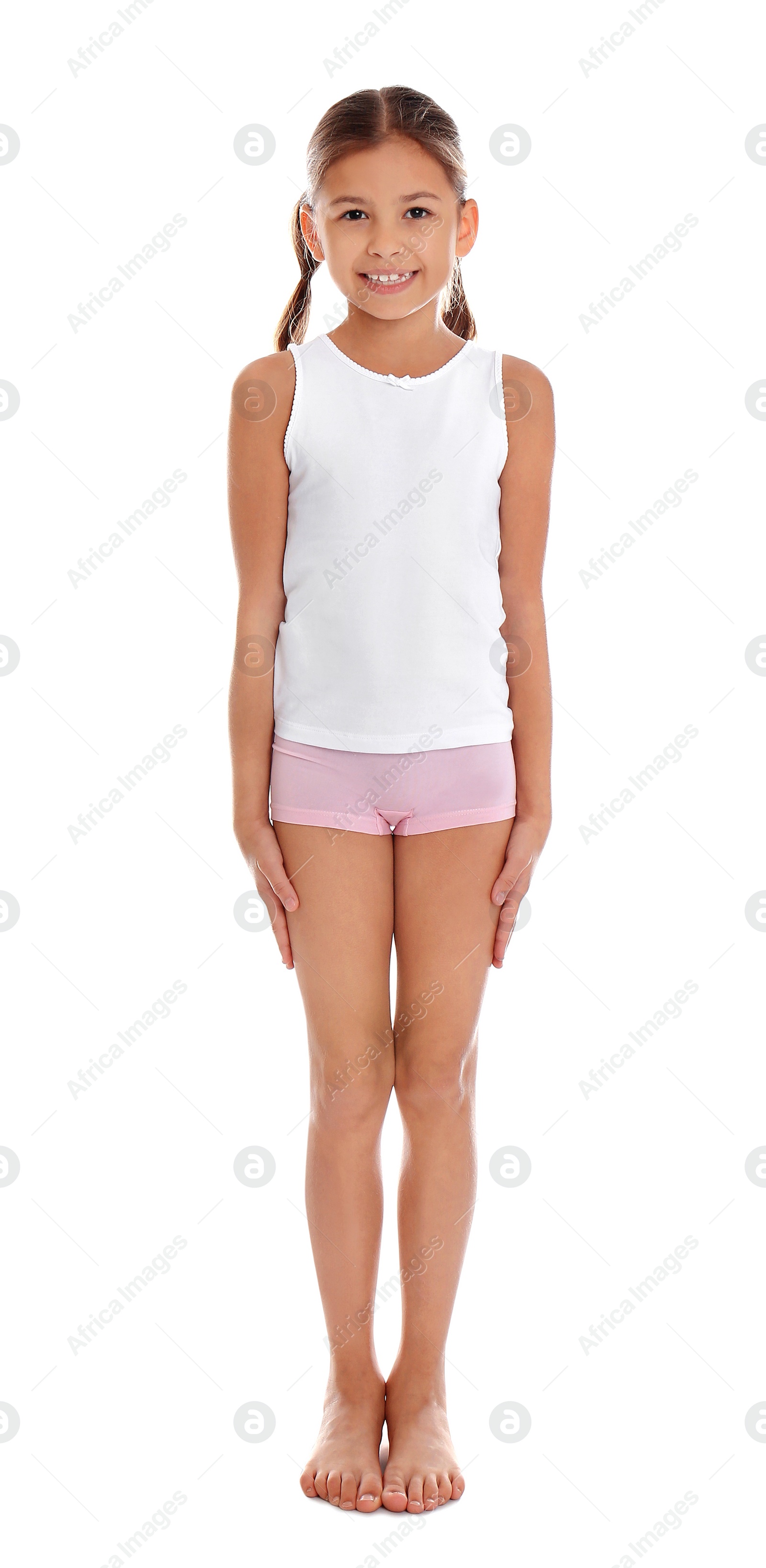 Photo of Cute little girl in underwear on white background