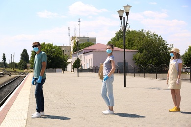 People keeping social distance in line at train station. Coronavirus pandemic