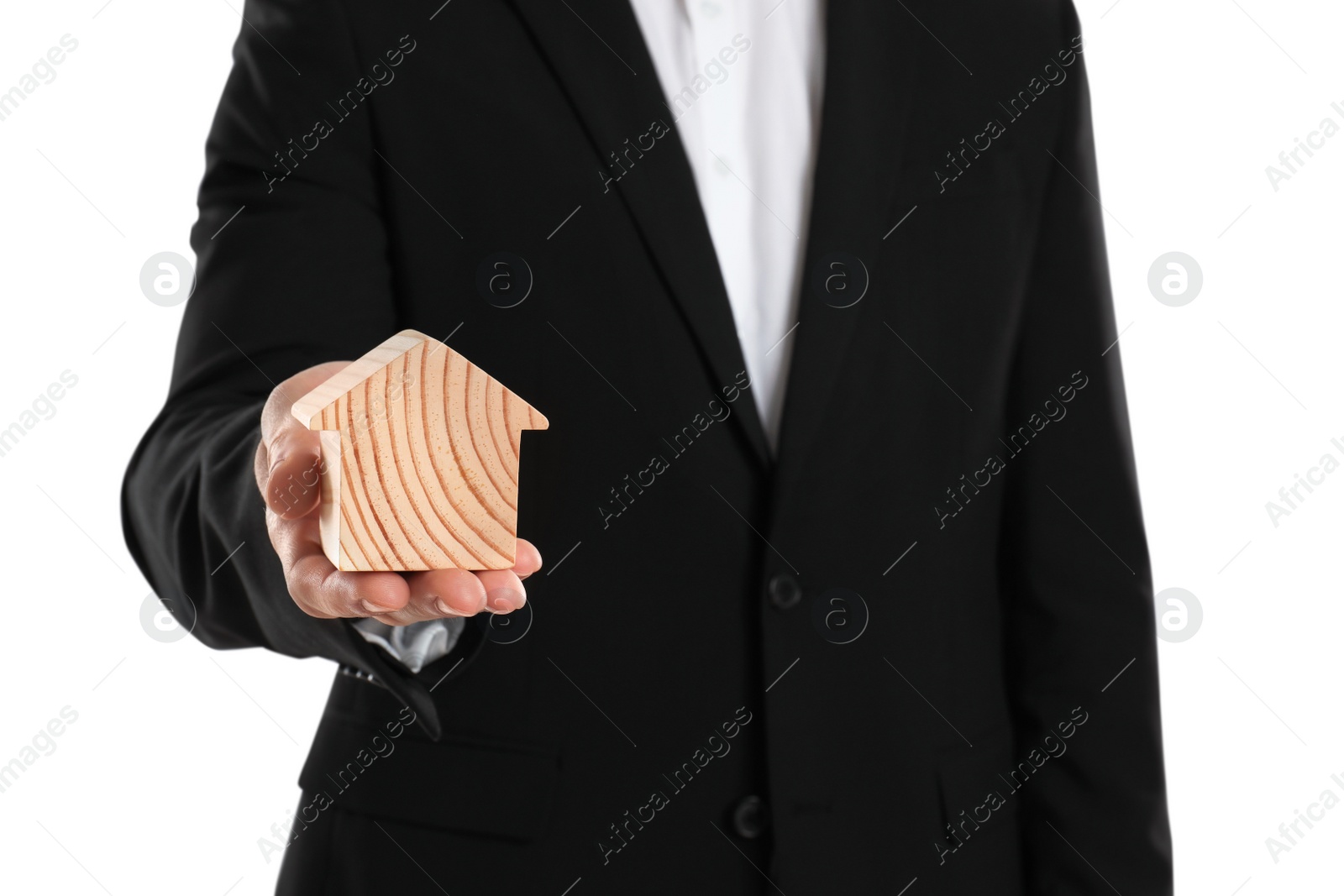 Photo of Real estate agent holding house figure on white background, closeup