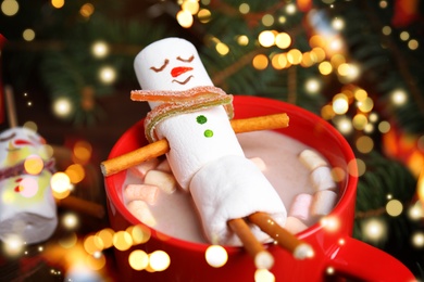 Image of Funny marshmallow snowman in cup of hot drink. Bokeh effect 
