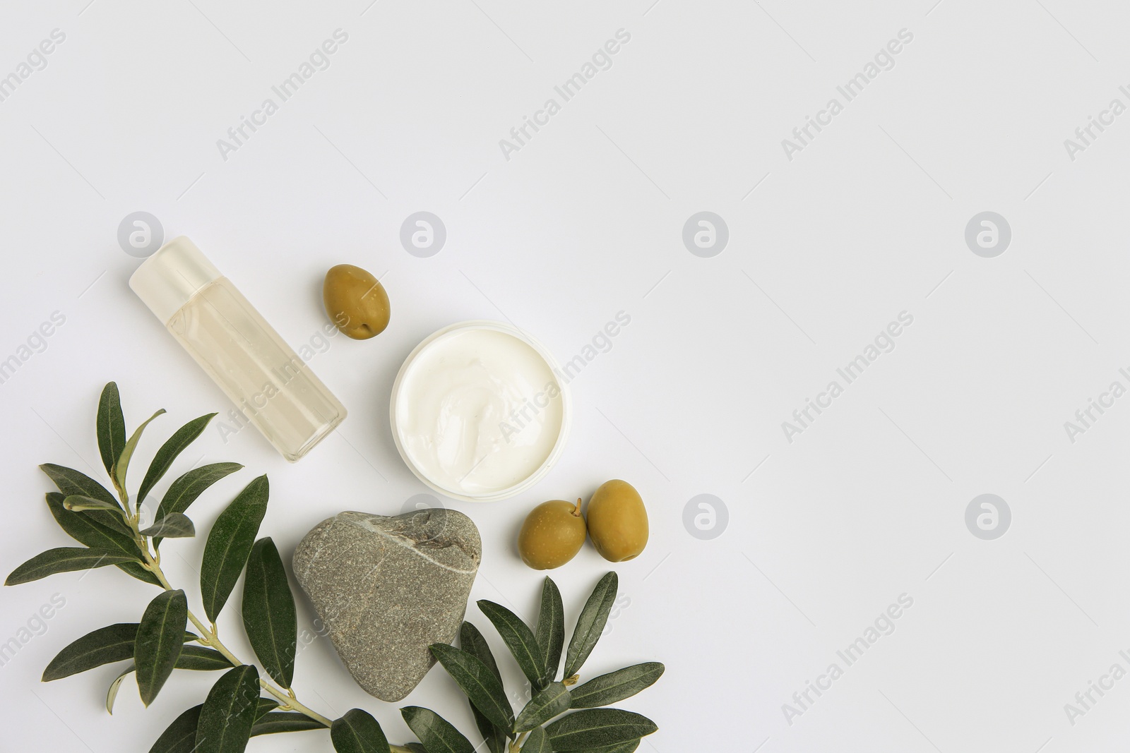 Photo of Flat lay composition with different cosmetic products and olives on white background. Space for text