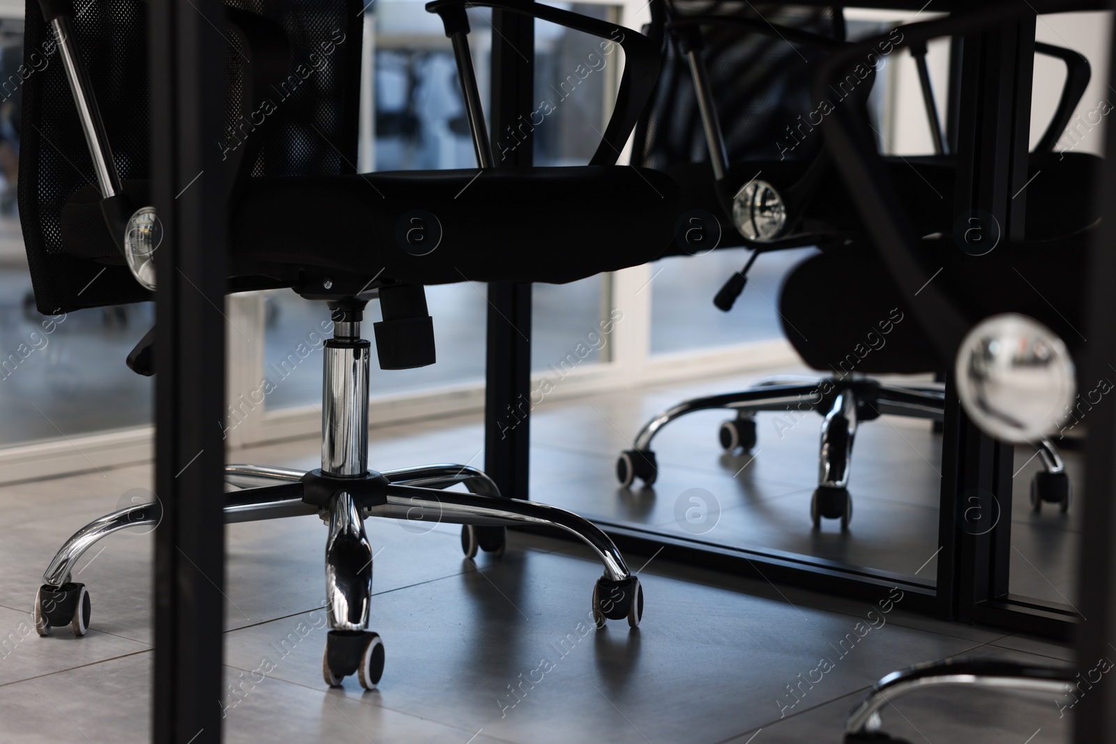 Photo of Comfortable office chairs and table in meeting room, closeup