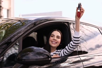 Photo of Woman holding car flip key inside her vehicle