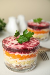 Herring under fur coat served on white table, space  for text. Traditional russian salad