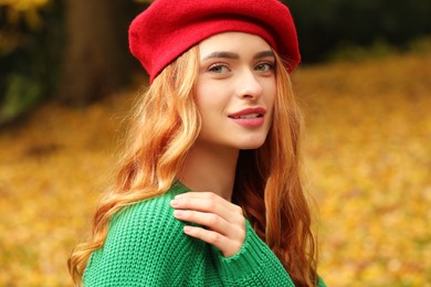 Portrait of beautiful woman wearing autumn sweater outdoors