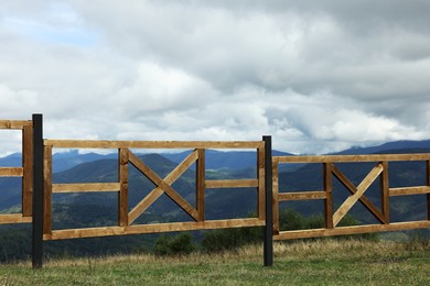Photo of Wooden fence and picturesque view of mountain landscape