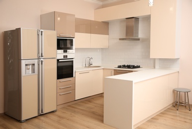 Photo of Interior of spacious modern kitchen with refrigerator