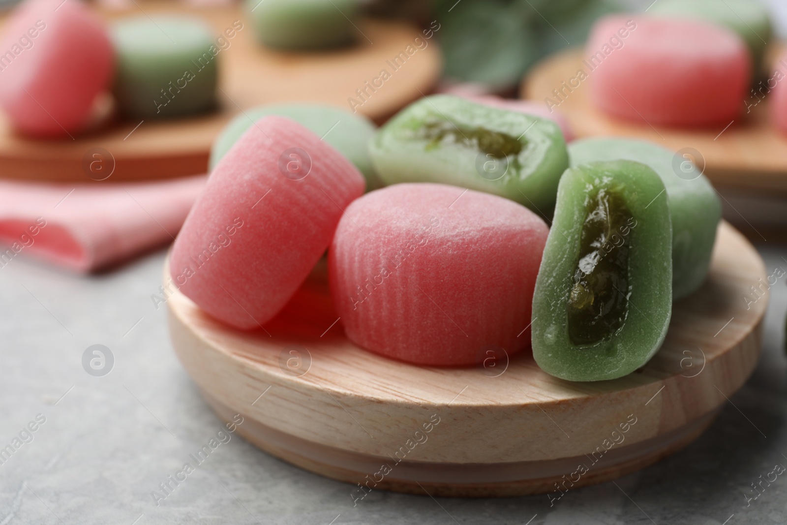 Photo of Many different delicious mochi on wooden board, closeup. Traditional Japanese dessert