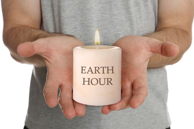 Image of Turn off lights for Earth hour. Man holding burning candle on white background, closeup