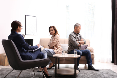 Photo of Psychotherapist working with couple in office. Family counselling
