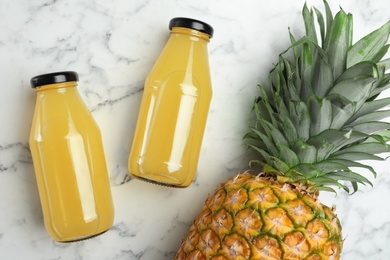 Delicious pineapple juice and fresh fruit on white marble table, flat lay