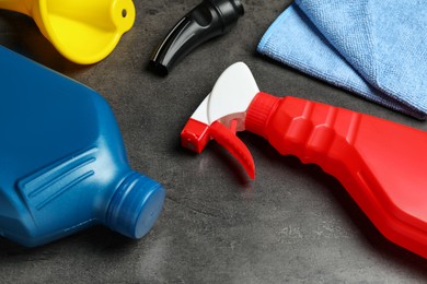 Photo of Different car cleaning products on dark background, closeup