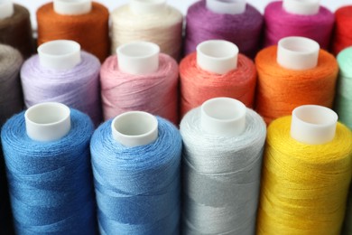 Photo of Set of different colorful sewing threads, closeup