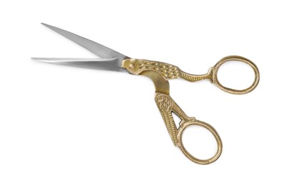 Photo of Pairscissors with ornate handles isolated on white, top view