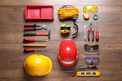 Flat lay composition with different construction tools on wooden background