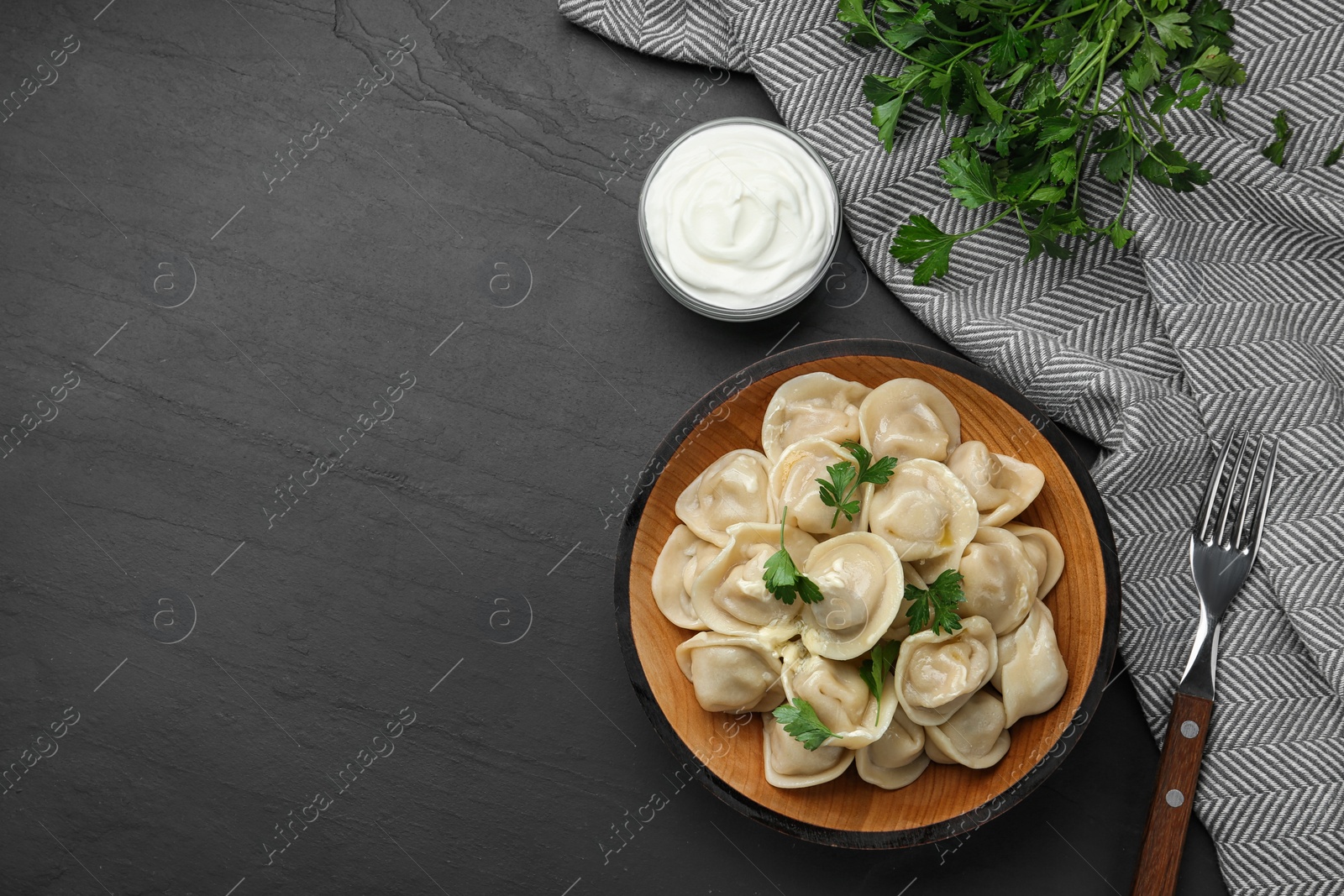 Photo of Flat lay composition with tasty dumplings on black table, flat lay. Space for text