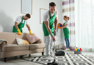 Photo of Cleaning service team at work in living room