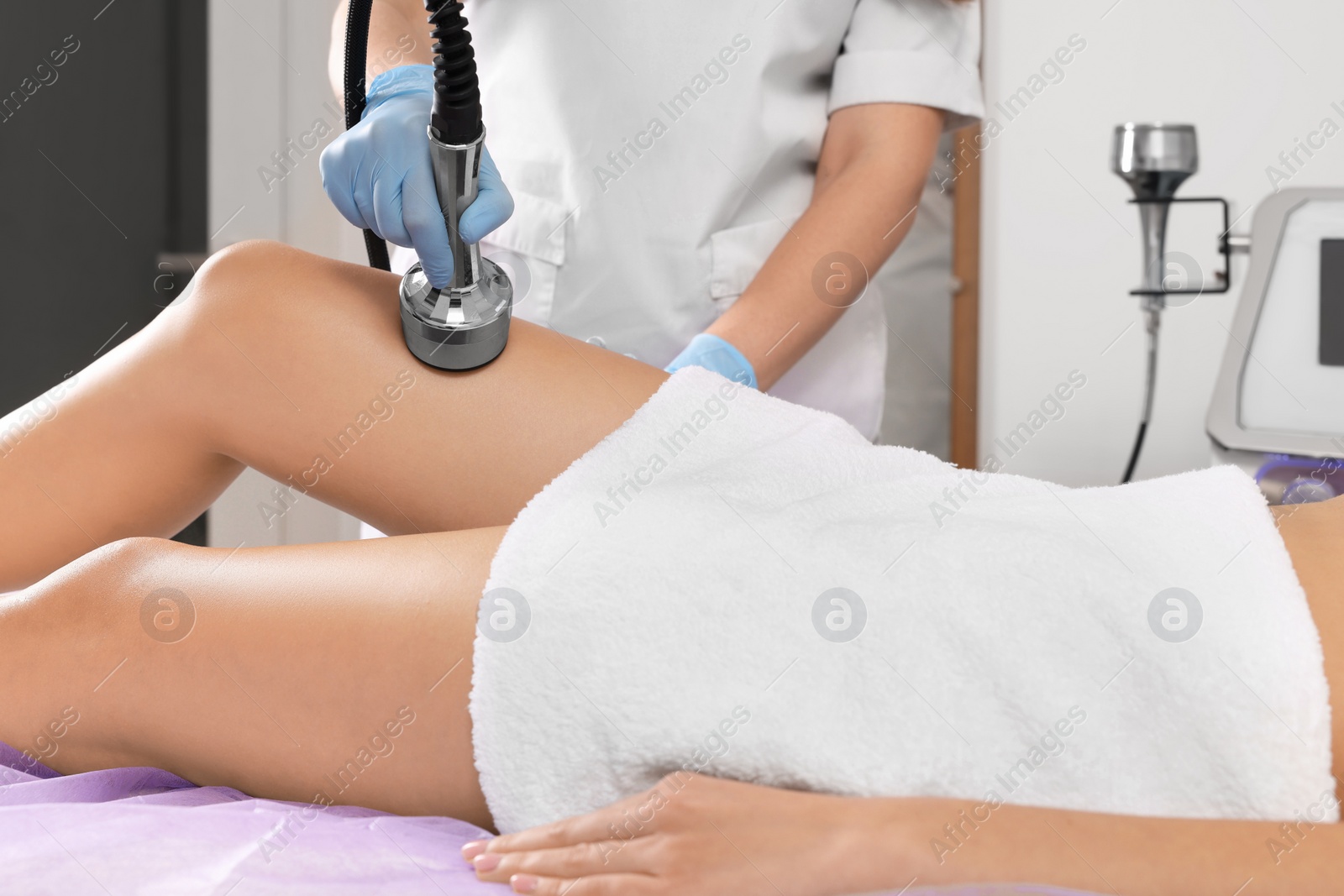 Photo of Woman undergoing radio frequency lifting procedure in beauty salon, closeup