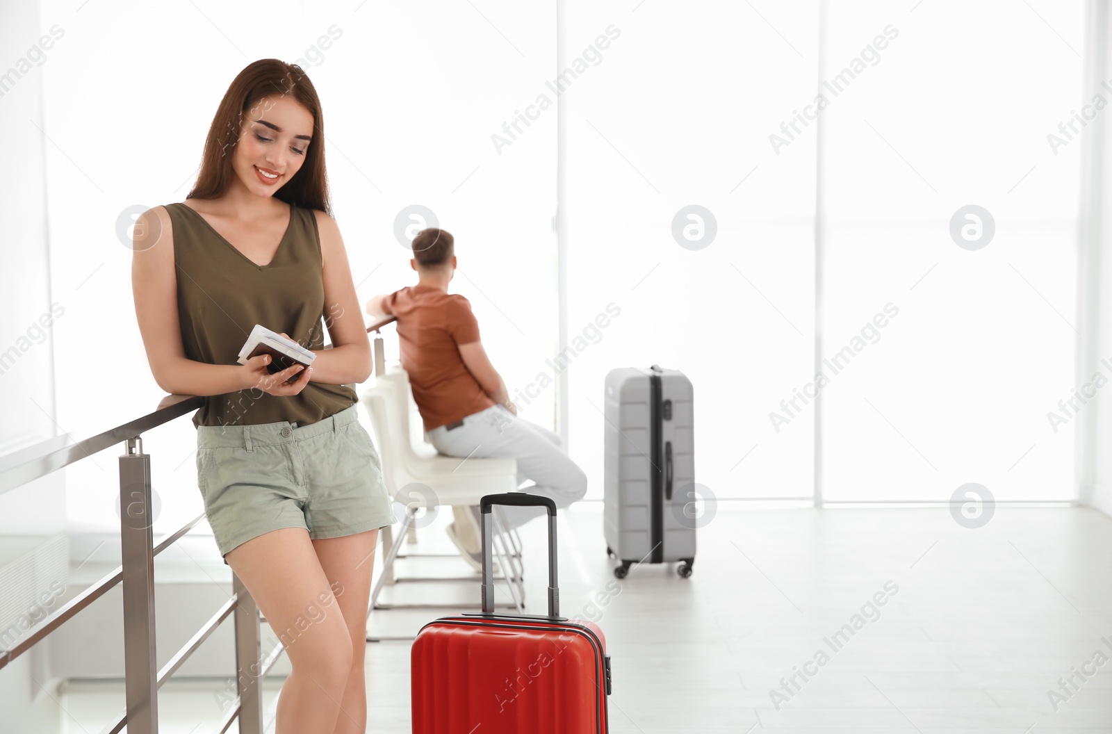 Photo of Young woman with suitcase in airport