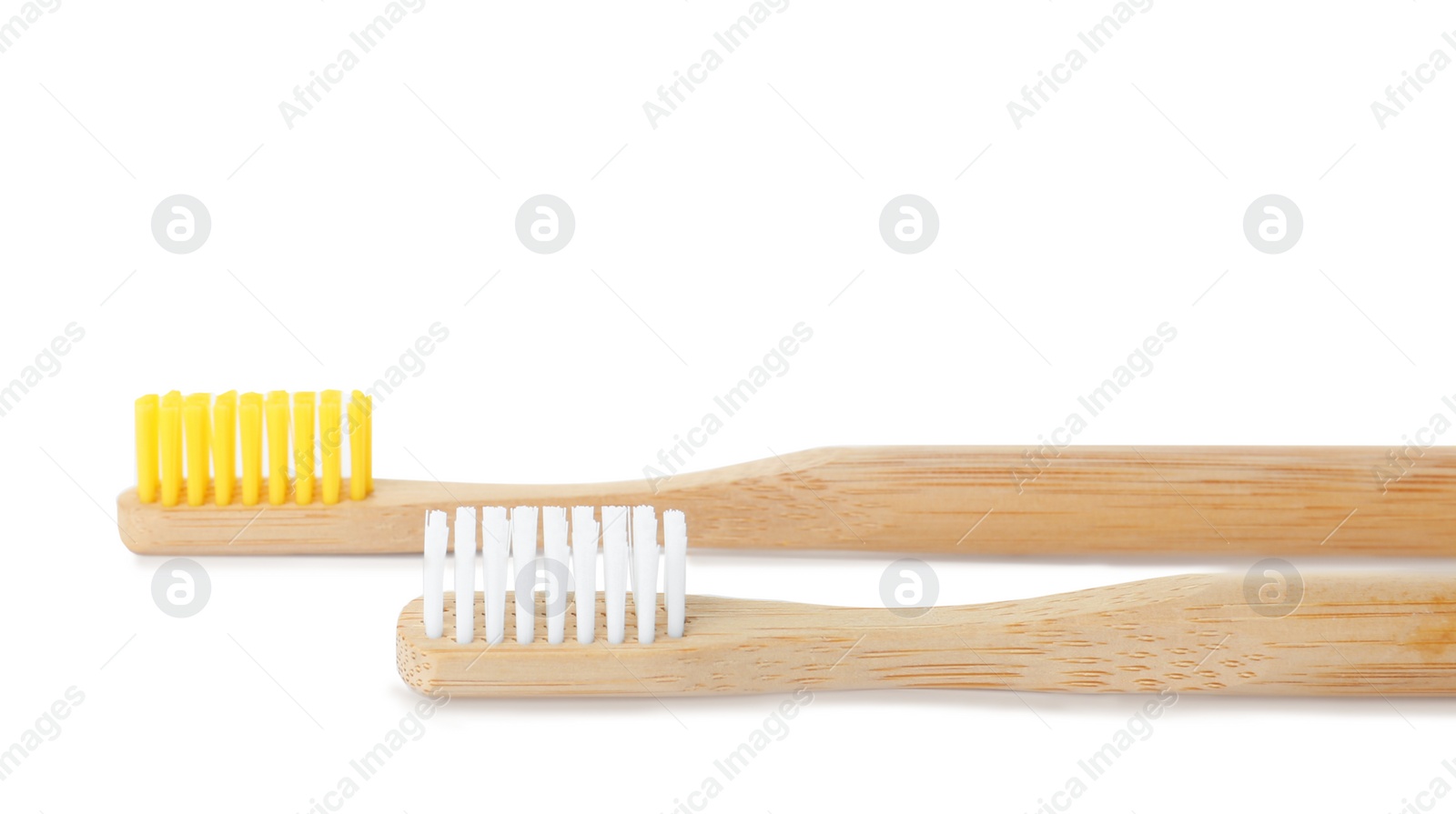 Photo of Bamboo toothbrushes on white background. Dental care