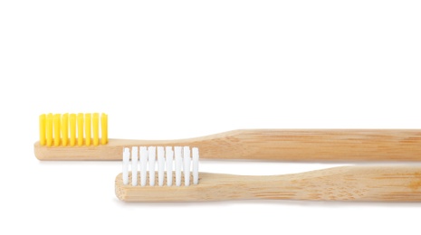 Photo of Bamboo toothbrushes on white background. Dental care