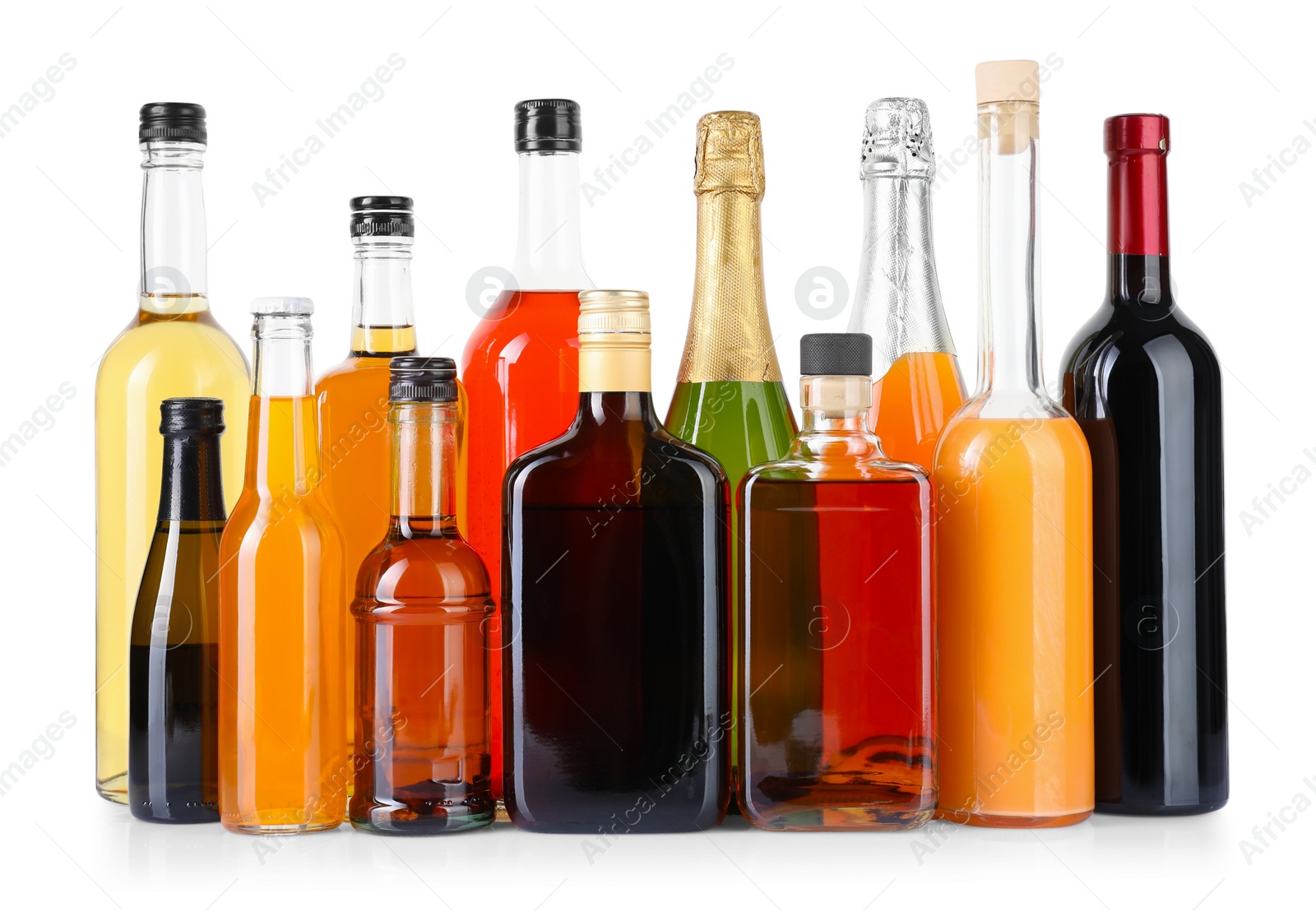 Photo of Bottles of different alcoholic drinks isolated on white