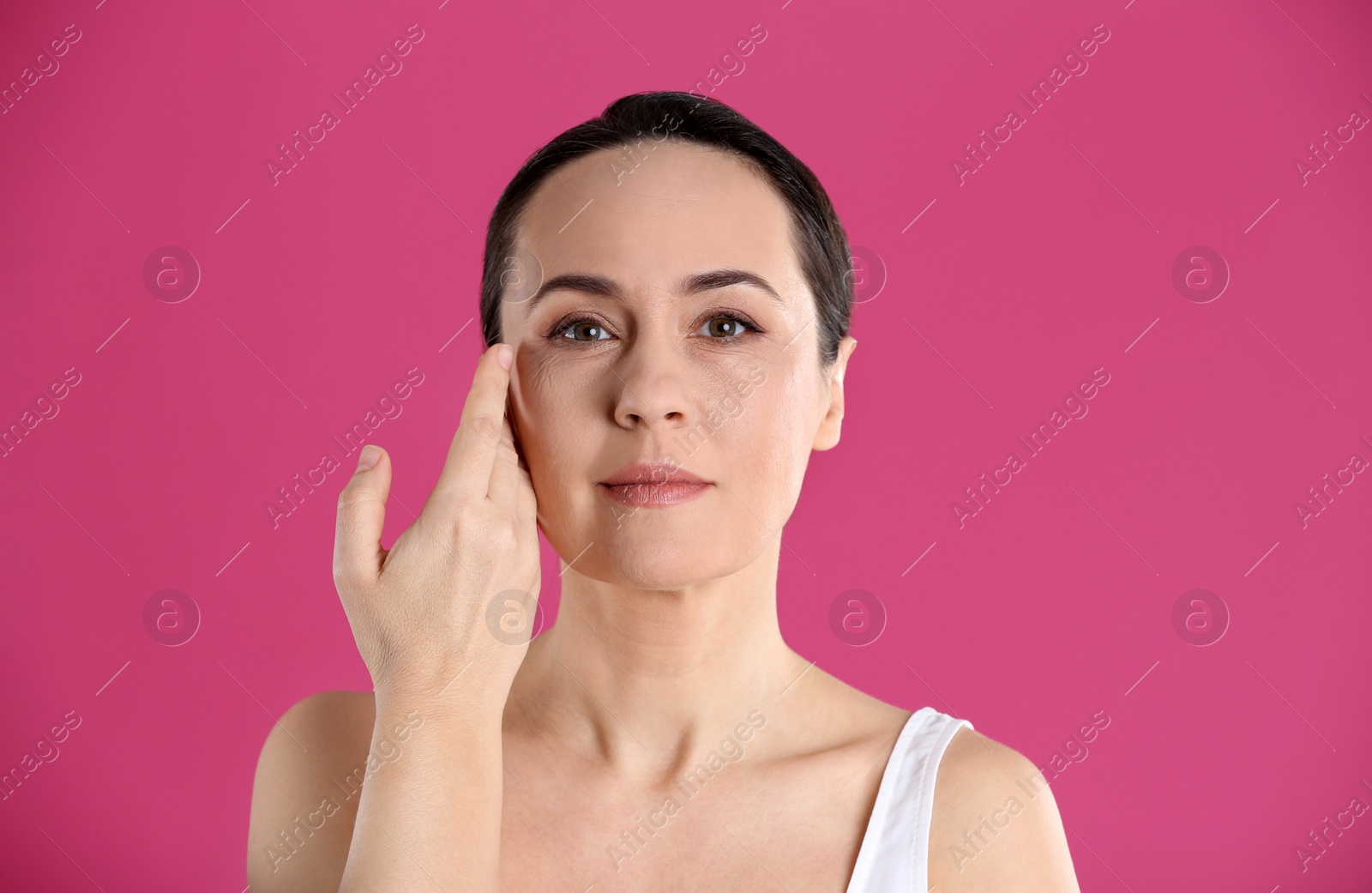 Photo of Portrait of beautiful mature woman on pink background