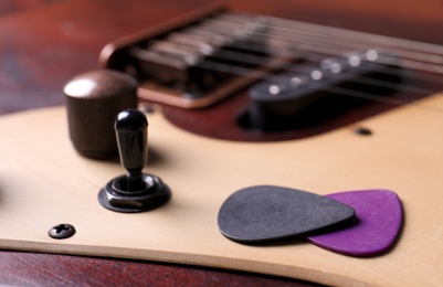 Photo of Plectrums on modern electric guitar, closeup view