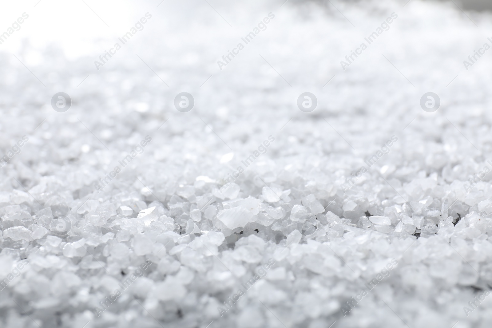 Photo of White natural salt as background, closeup view