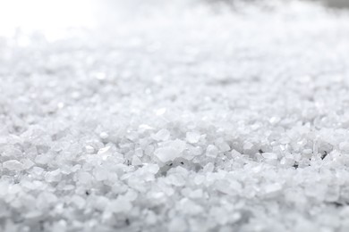 Photo of White natural salt as background, closeup view