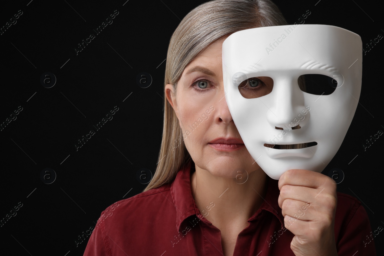 Photo of Multiple personality concept. Woman with mask on black background