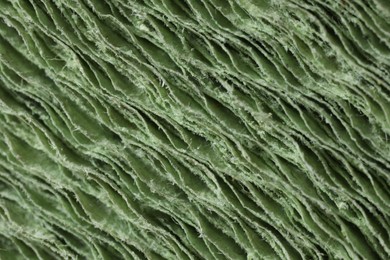 Photo of Texture of stacked light green paper napkins as background, macro view
