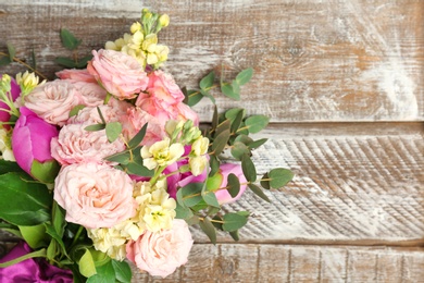 Photo of Bouquet of beautiful fragrant flowers on wooden background