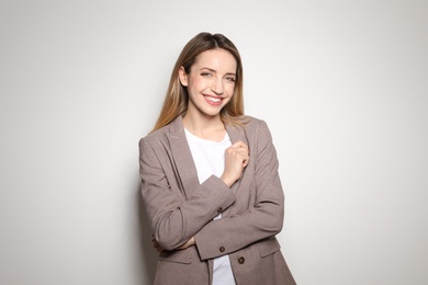 Portrait of young woman with beautiful face on light background