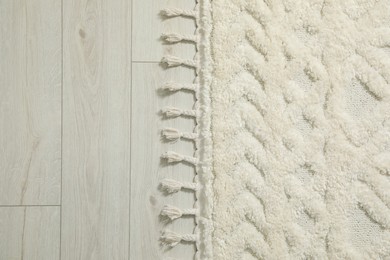 Photo of Beautiful white carpet with pattern on floor, top view. Space for text