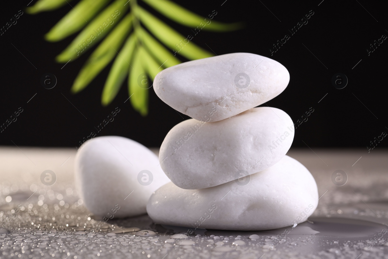 Photo of White spa stones with water drops on grey background