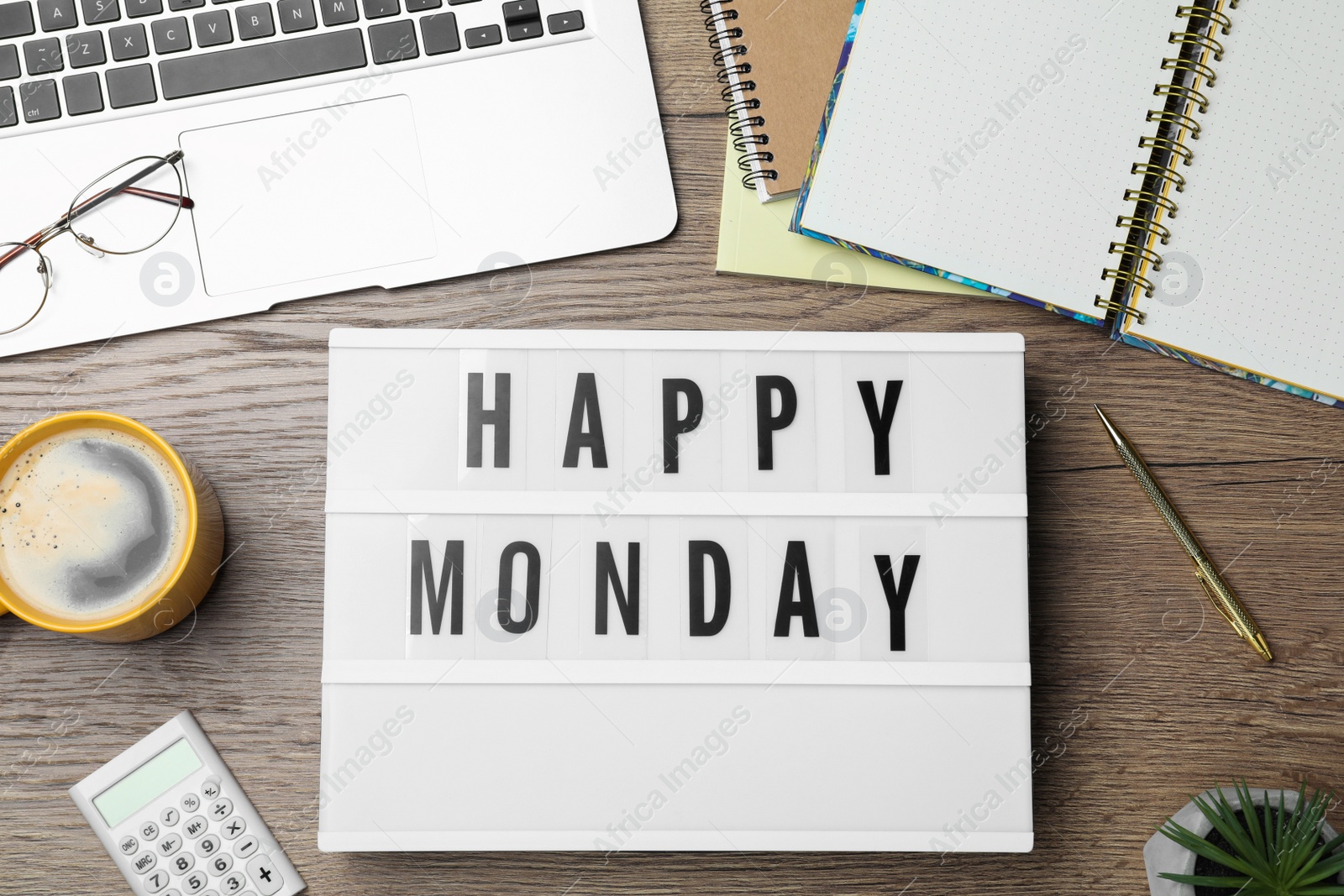 Photo of Light box with message Happy Monday, office stationery and cup of coffee on wooden desk, flat lay