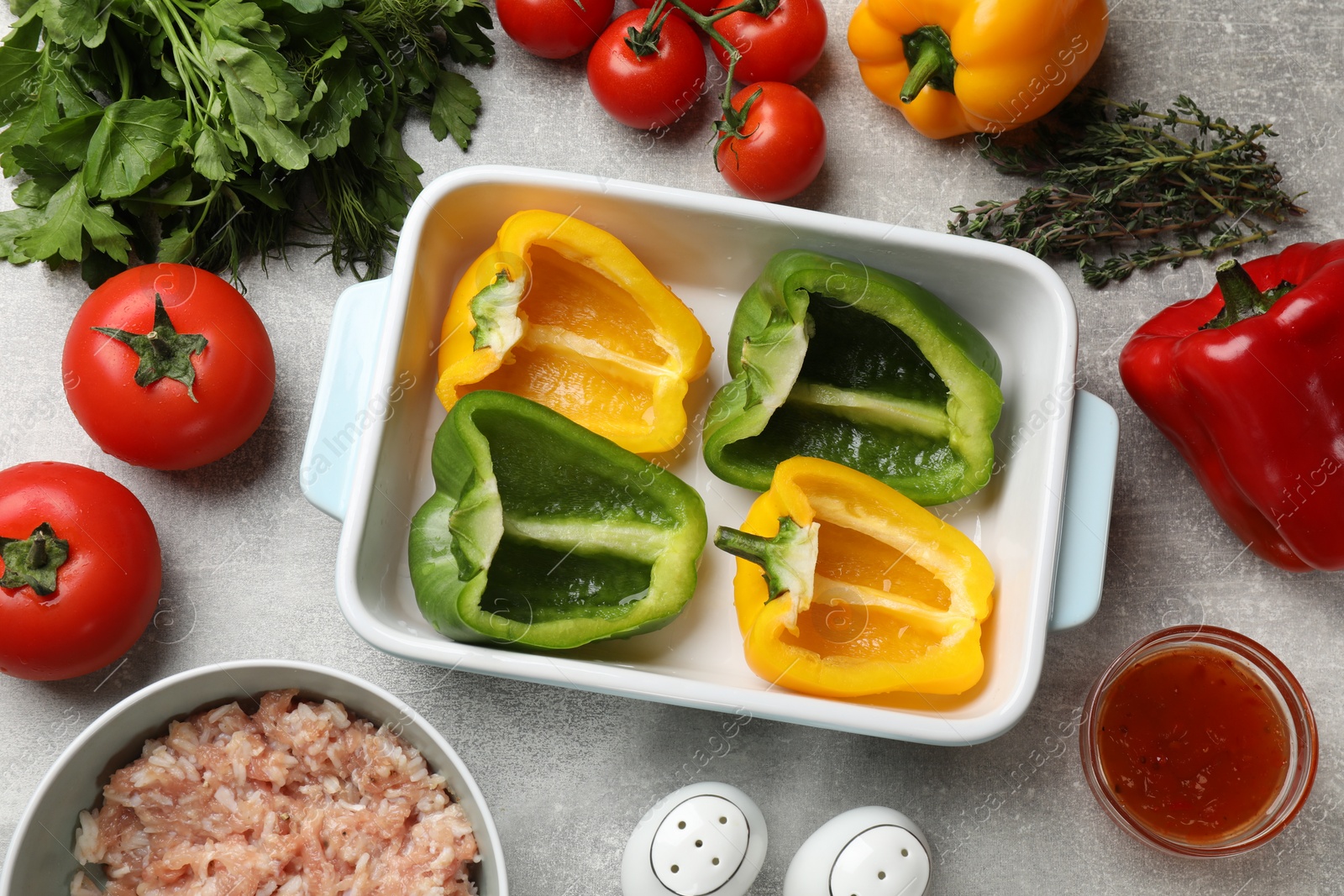 Photo of Making stuffed peppers. Vegetables and ground meat on grey table, flat lay